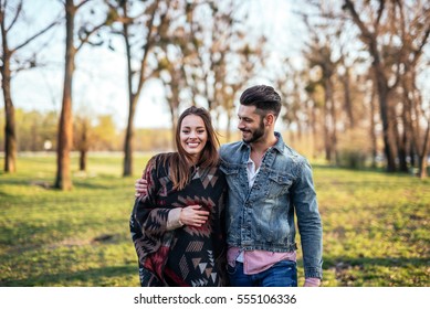 Couple In Love Enjoying A Walk On A Sunny Spring Day.