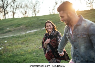 Couple In Love Enjoying A Walk On A Sunny Spring Day.