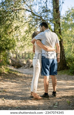 Couple in love enjoying a walk in the woods at sunset