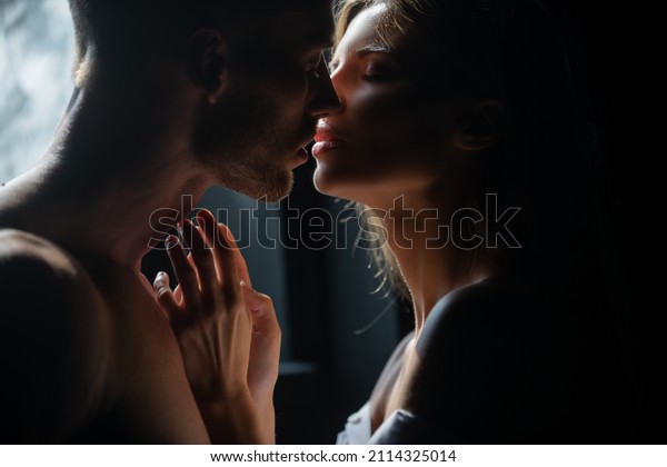 Couple in love face to face, tender hugging and
kissing. Beautiful woman and handsome man boyfriend. Couple in love
going for the kiss.