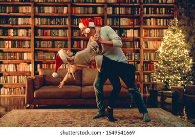 Couple In Love Feeling Happiness About Their Romance Spending Christmas Or New Year  Together, Woman And Man Enjoying Perfect Relationships And Spending Winter Vacations In Cozy Home Interior.