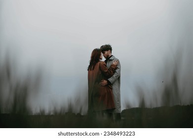 couple in love in a foggy field. Relationship crisis and dramatic love concept. sstkLOVE