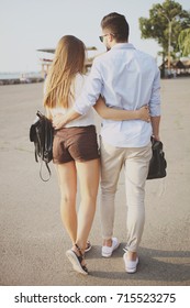 Couple in love: a guy and a girl embrace while walking. - Shutterstock ID 715523275