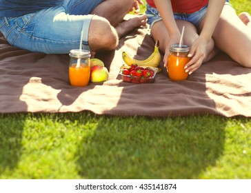 couple in love have fun in the park and drink smoothies and eating fruit at a picnic
 - Powered by Shutterstock