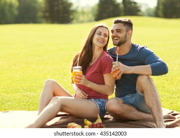 couple in love have fun in the park and drink smoothies and eating fruit at a picnic
 - Powered by Shutterstock