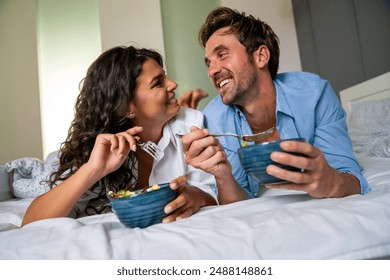 Couple in love having breakfast in bed. People, love, food concept. - Powered by Shutterstock