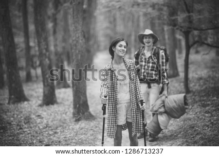 Similar – Women friends laughing while walking in forest