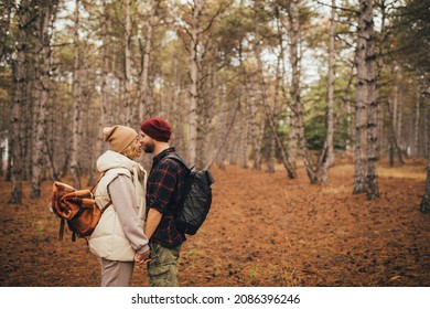 Couple In Love Hiking Together In A Pine Forest. Millennial Hipsters Travelers Spending Time Together.