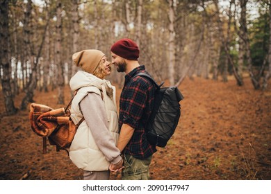 Couple In Love Hiking Together In A Pine Forest. Millennial Hipsters Travelers Spending Time Together.