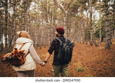 Couple In Love Hiking Together In A Pine Forest. Millennial Hipsters Travelers Spending Time Together.