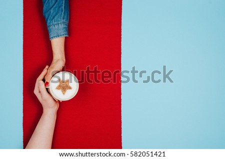 Couple in love holding hands with coffee on colorful table. Photograph taken from above, top view with copy space