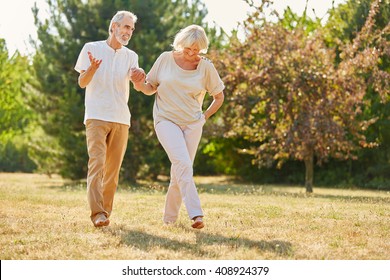 Couple in love holding hands on a walk in the park in summer