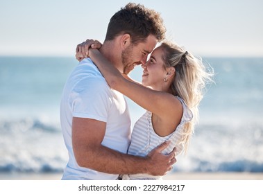 Couple, love and hug at the beach together, nose touch and bonding with travel and date by the ocean for summer holiday. Happy, man and woman with quality time, sea waves and romantic out in nature. - Powered by Shutterstock