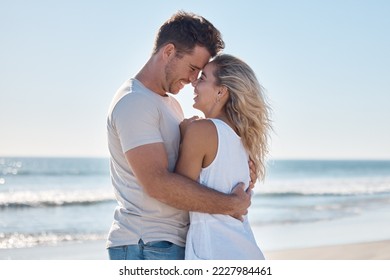 Couple, love and hug in relationship at the beach for summer vacation or romantic bonding in the outdoors. Happy man and woman hugging with smile together in loving embrace for romance by the ocean - Powered by Shutterstock