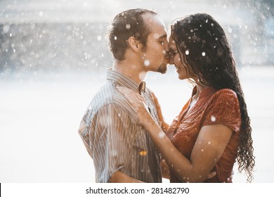 Couple In Love Hugging And Kissing Under Summer Rain