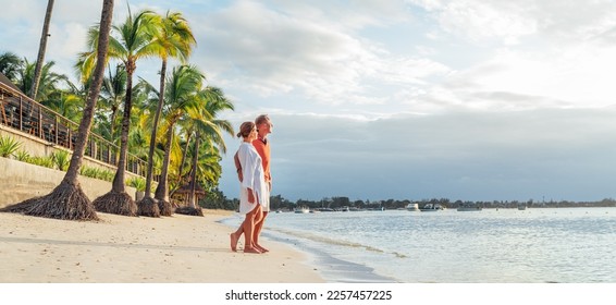 Couple in love hugging on sandy exotic beach while having evening walk by Trou-aux-Biches seashore on Mauritius island enjoying sunset. People relationship and tropic honeymoon vacations concept image - Shutterstock ID 2257457225