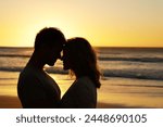 Couple, love and kiss at ocean with silhouette for date or summer holiday and bonding in Florida. Relationship, commitment and romance together as soulmate with smile, happy and vacation or honeymoon
