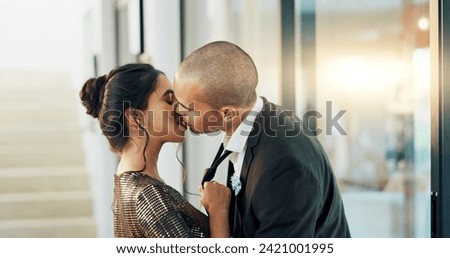 Couple, love and kiss with passion on a date for formal event, intimacy and romance on valentines day at home. Lovers, woman and man in luxury house, suit and dress for anniversary or relationship