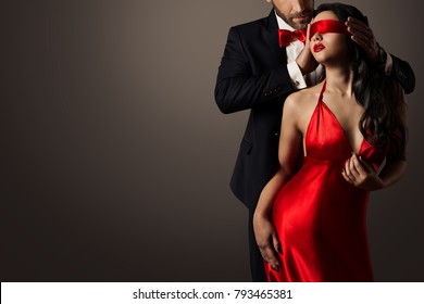 Couple Love Kiss, Sexy Blindfolded Woman Dancing in Red Dress and Elegant Man in Suit