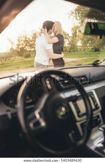 couple in love kisses\
traveling by car