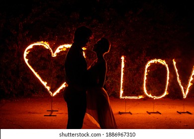 Couple In Love Kissing Near Burning Fire Letters Love And Heart