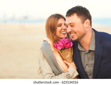 Couple in love laughing looking at each other in the sea