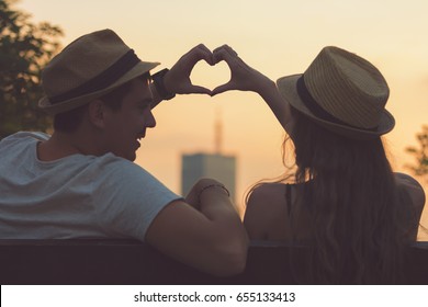 Couple In Love Making A Heart - Shape With Hands.