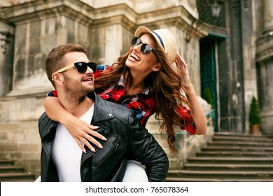 Couple In Love. Man Carrying Girl On His Back On Street. Smiling Male With Beautiful Young Woman Having Fun Spending Time Together. Relationships Concept. High Quality Image. - Powered by Shutterstock