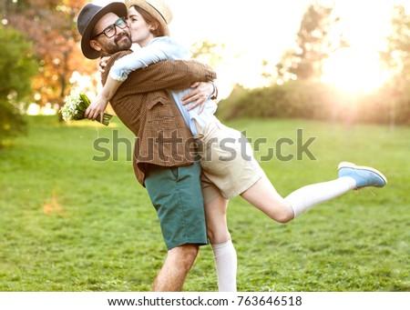 Couple in love in nature hugging with flowers on St. Valentine's Day