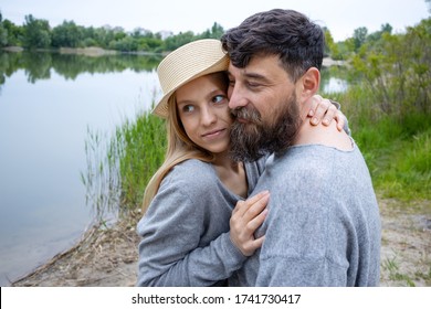 Couple In Love On A Background Of Lake Nature. Relations Between People With A Big Age Difference.