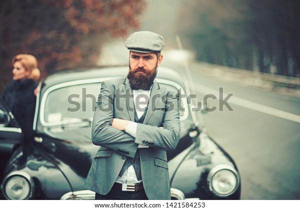 Couple\
in love on date. Escort of girl by security. Bearded man and sexy\
woman in fur coat. Travel and business trip or hitch hiking. Retro\
collection car and auto repair by mechanic\
driver