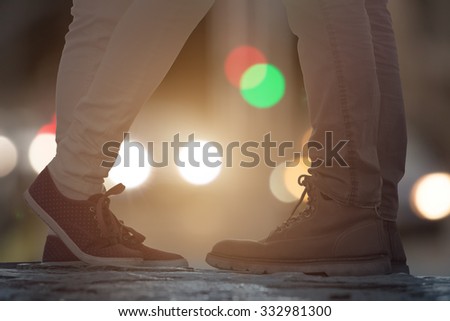 Couple in love on the street with defocused city lights.