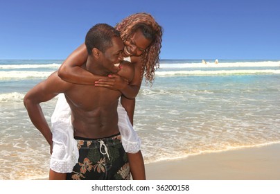 Couple in Love Playing on the Beach on the Ocean Water