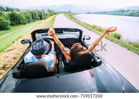 Couple in love ride in cabriolet car