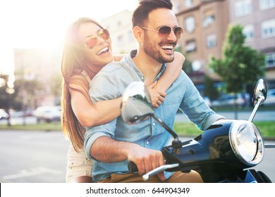 Couple in love riding a motorbike. Handsome guy and young sexy woman travel.