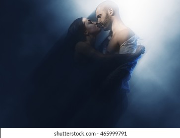 Couple in love. Sensual brunette and handsome man kissing. Image with a blurry effect