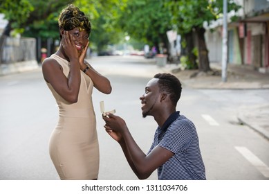 Couple in love, share emotions.Young couple in love outdoors. Concept of love, relationship and people. man asking the hand of a woman on the street in summer - Powered by Shutterstock