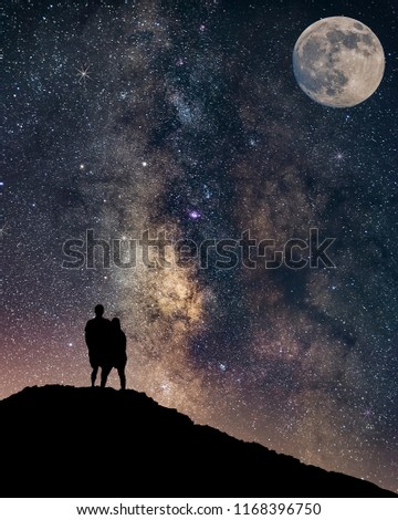 Couple in love silhouette and the Milky way, love and valentines concept, long exposure astronomical photograph full moon and milkyway, apic shot from israel desert.