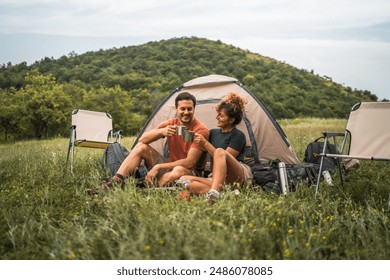 couple in love sit on the grass enjoy camp with coffee and talk - Powered by Shutterstock