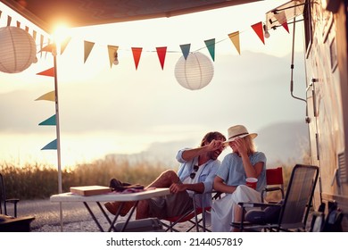 Couple In Love. Sitting In Front Of Camper Rv. Having Fun. Outdoors Summer Party. Fun, Togetherness, Nature Concept.