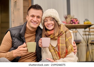 Couple In Love Sitting On The House Porch