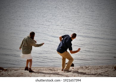 Couple In Love Skipping Rocks