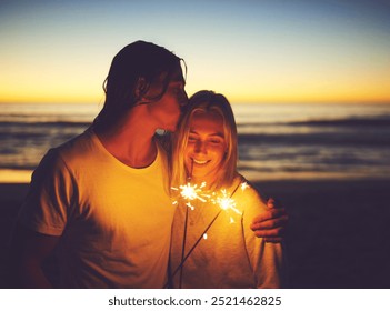 Couple, love and sparkler on beach at night for new year celebration, party event and kissing on holiday. Tourist, people and fireworks at ocean sunset for vacation, travel and romance with affection - Powered by Shutterstock