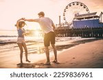 Couple in love spending time on the beach in santa monica, los angeles. Storytelling moments of a young man and woman in love, warm tones sunset editing