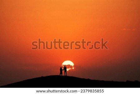 Similar – Two people watching the sunset