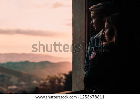 Couple in love at sunset in the mountains