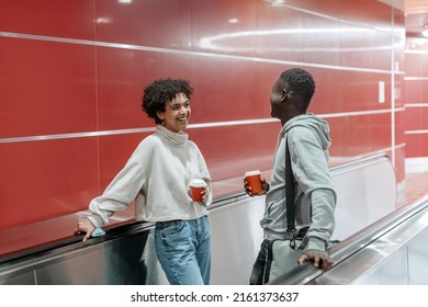 couple in love with a takeaway coffee is flirting on the subway