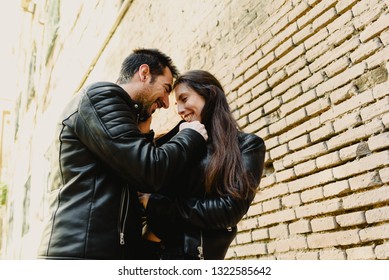 Couple In Love Tickling And Laughing Hard During A Casual Walk Through The City.