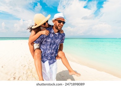 Couple in love tropical beach with turquoise ocean and sunshine .Maldives island. Having fun man carry woman on his back.Romantic holidays vacation. Just married get away holidays - Powered by Shutterstock