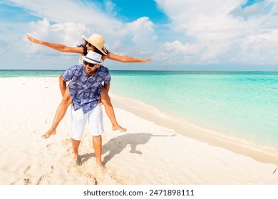 Couple in love tropical beach with turquoise ocean and sunshine .Maldives island. Having fun man carry woman on his back.Romantic holidays vacation. Just married get away holidays - Powered by Shutterstock